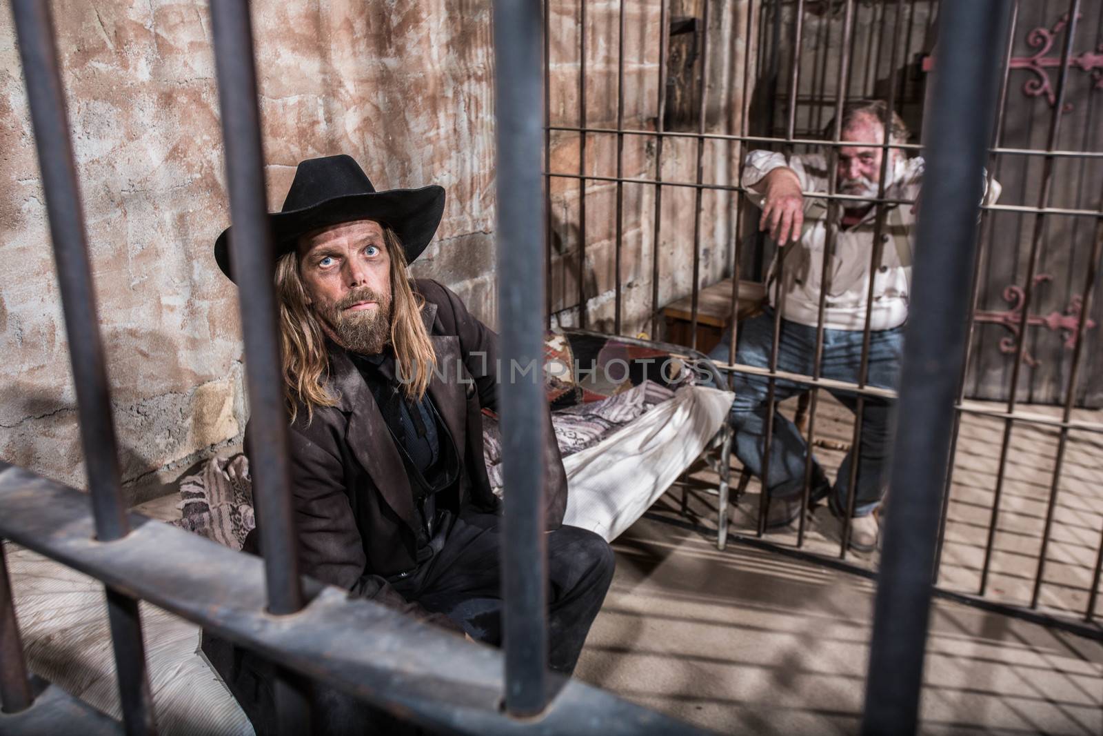 Two Imprisoned Men Wait in Jail Cell