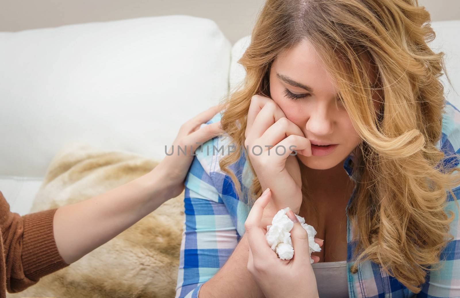 Hands of mother closeup consoling sad teen daughter crying by problems