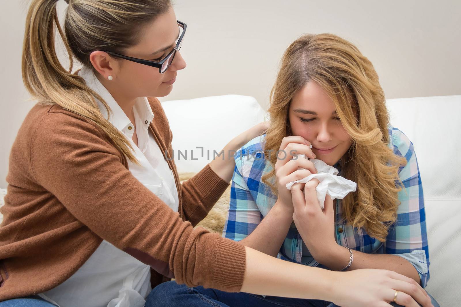 Mother soothes sad teen daughter crying by doble.d