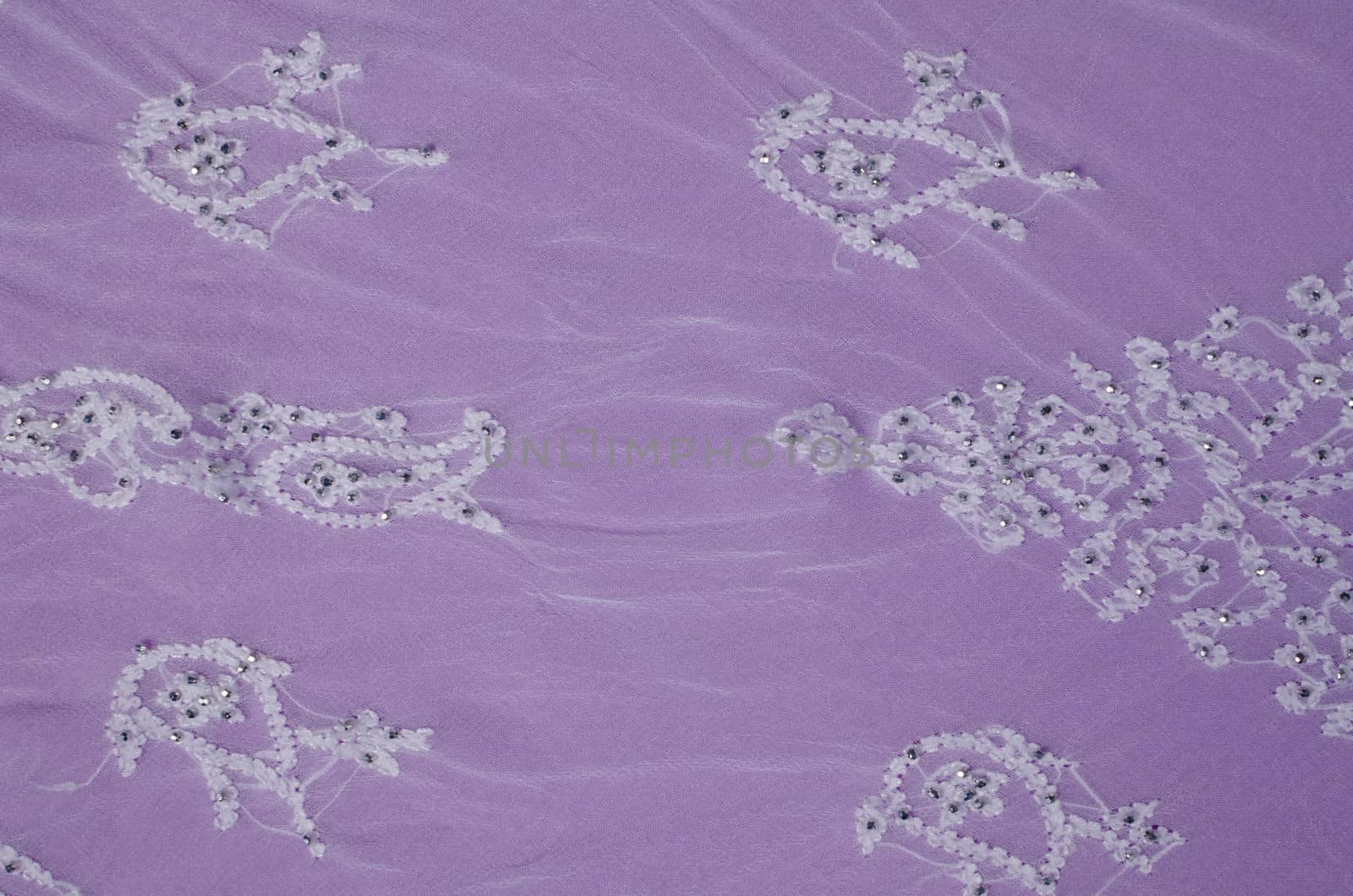 Elegant embroidery  on a  purple colored fabric