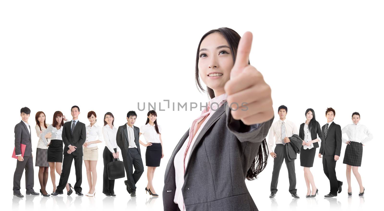 Attractive Asian business woman give you an excellent sign and stand in front of her team.