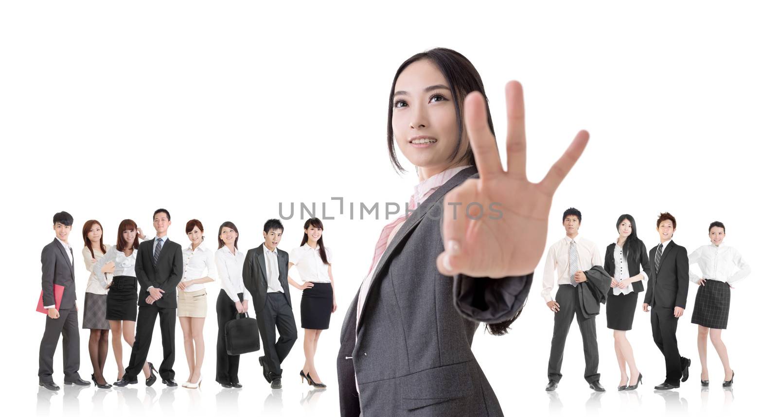Attractive Asian business woman give you an okay sign and stand in front of her team.