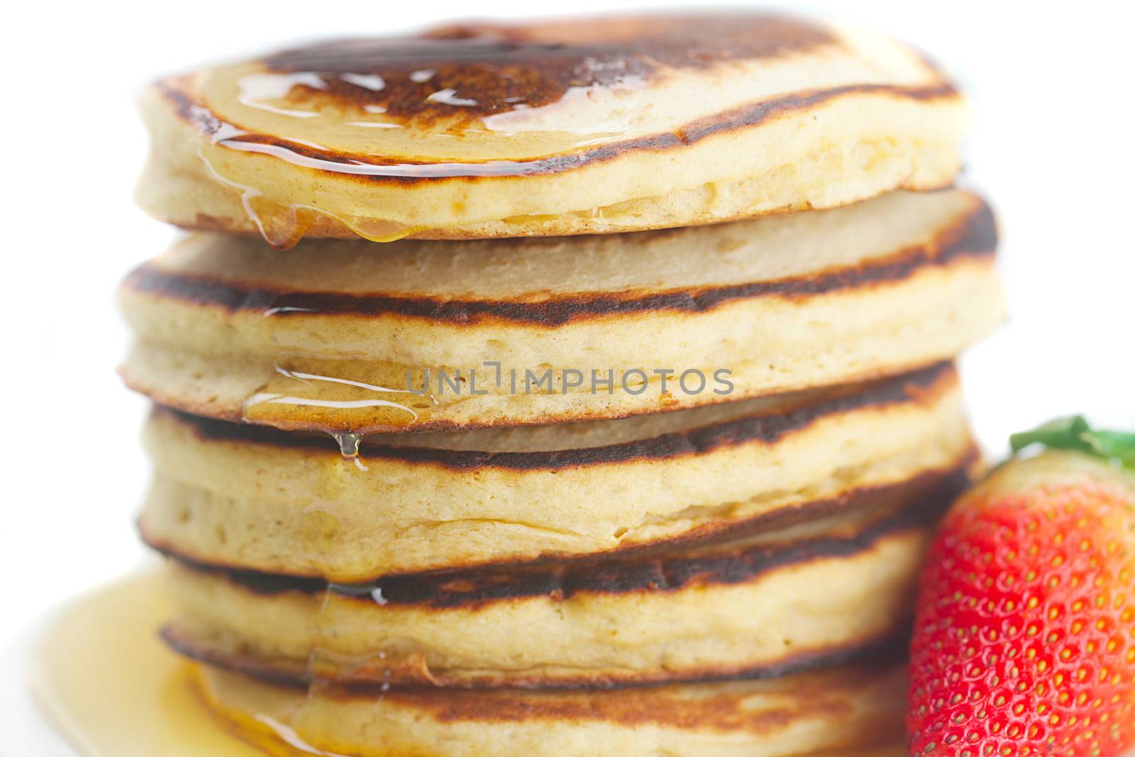 Pancakes, honey and strawberry isolated on white