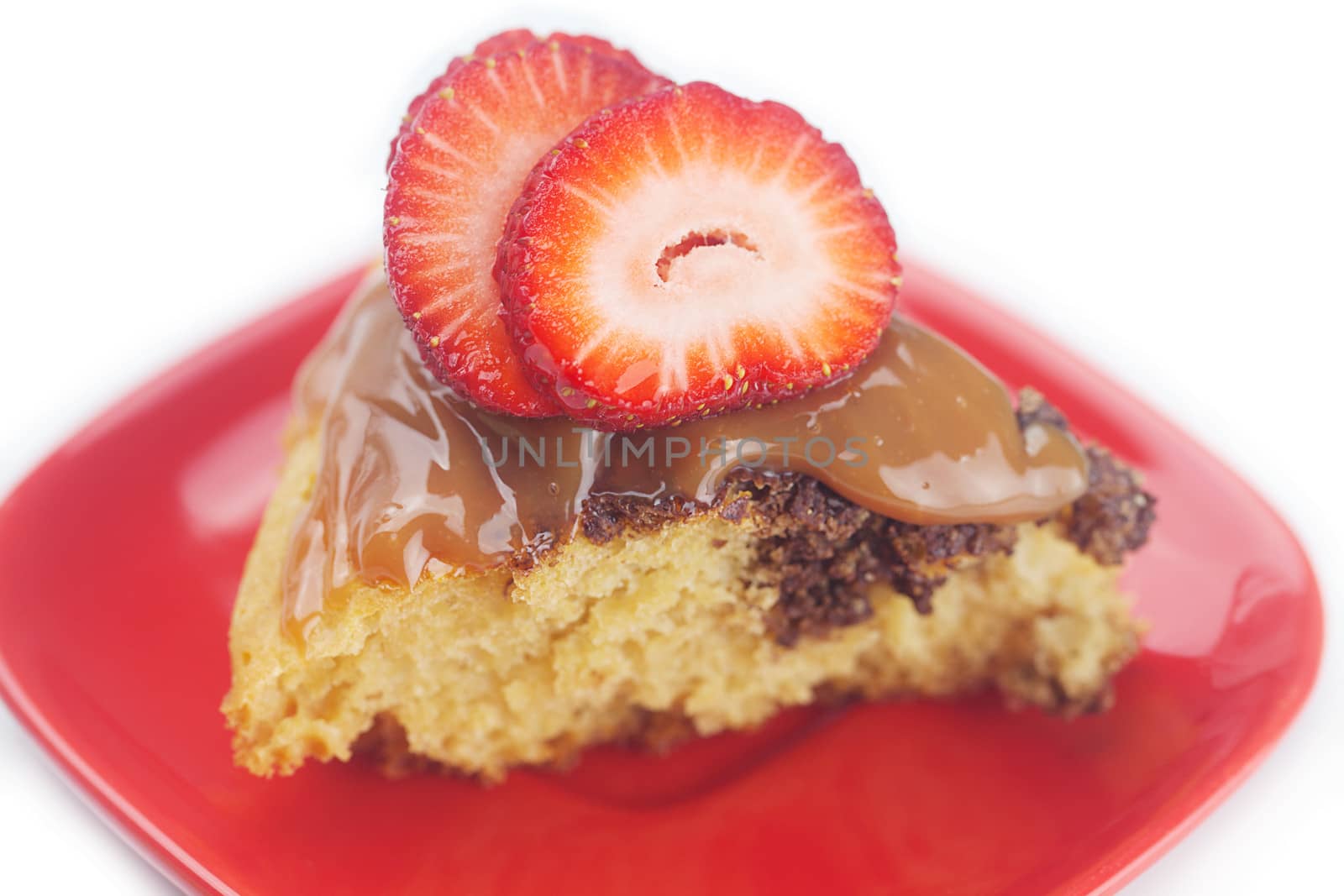 cake with condensed milk and strawberries isolated on white by jannyjus