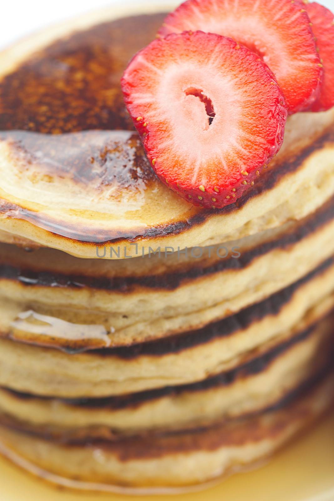 Pancakes, honey and strawberry isolated on white by jannyjus