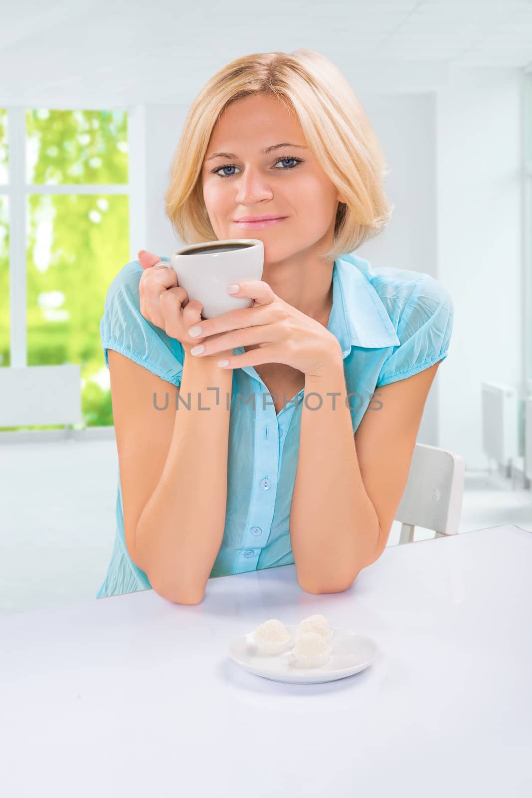 beautiful female drinking coffe at table