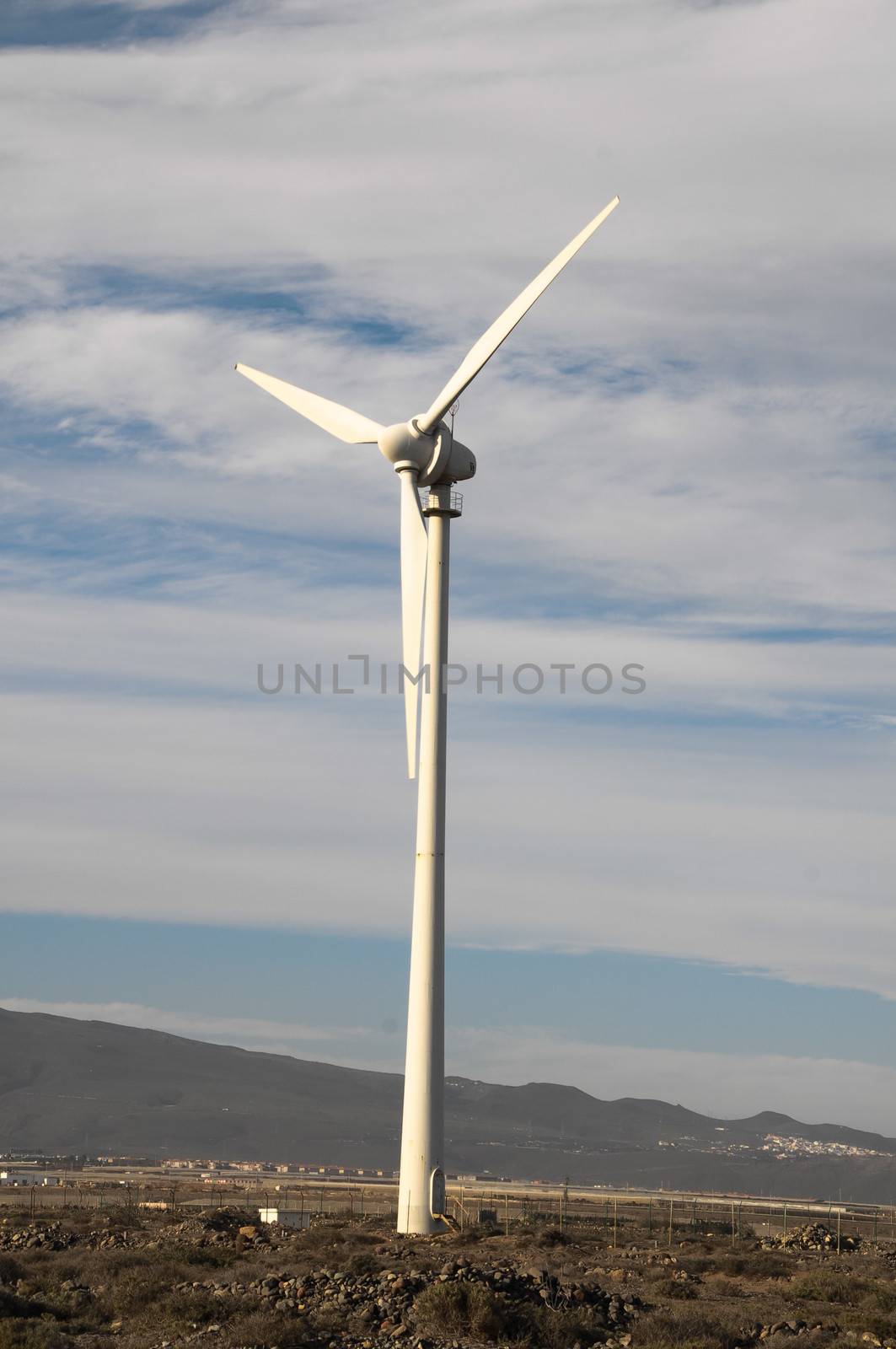 Eletric Power Generator Wind Turbine over a Cloudy Sky