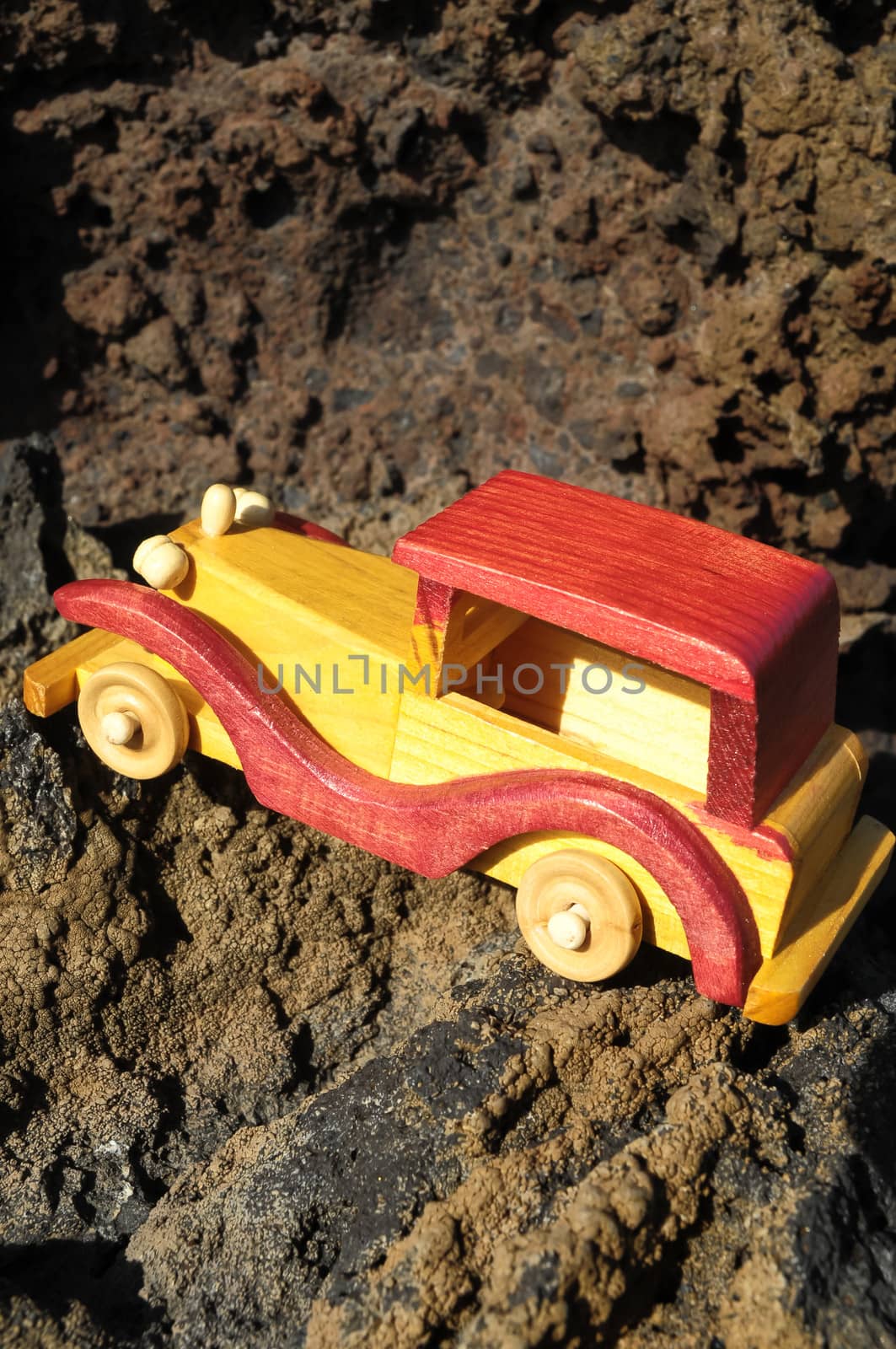 Transportation Concept Wooden Toy Car on the Rocks