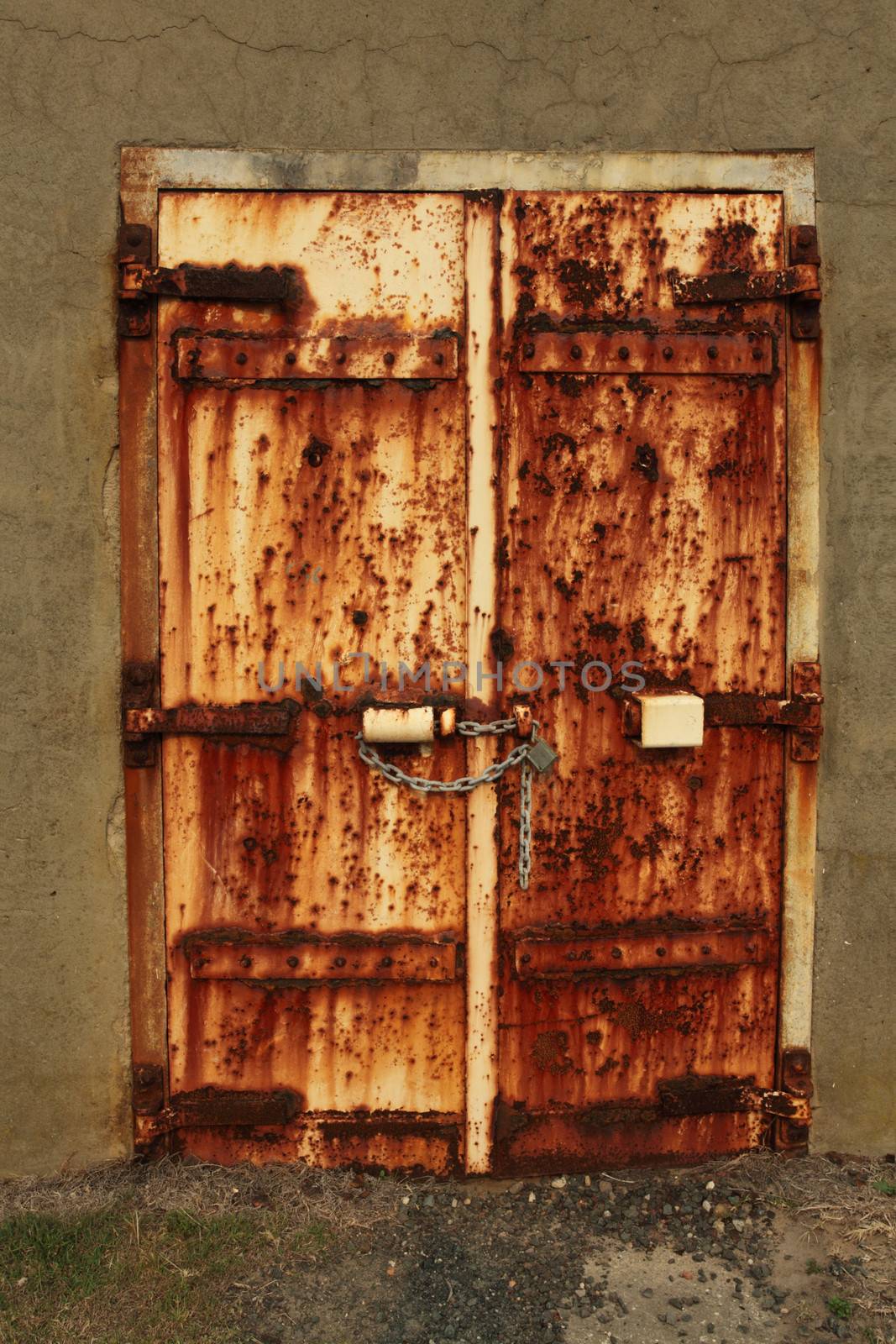 Rusty padlocked door by lovleah