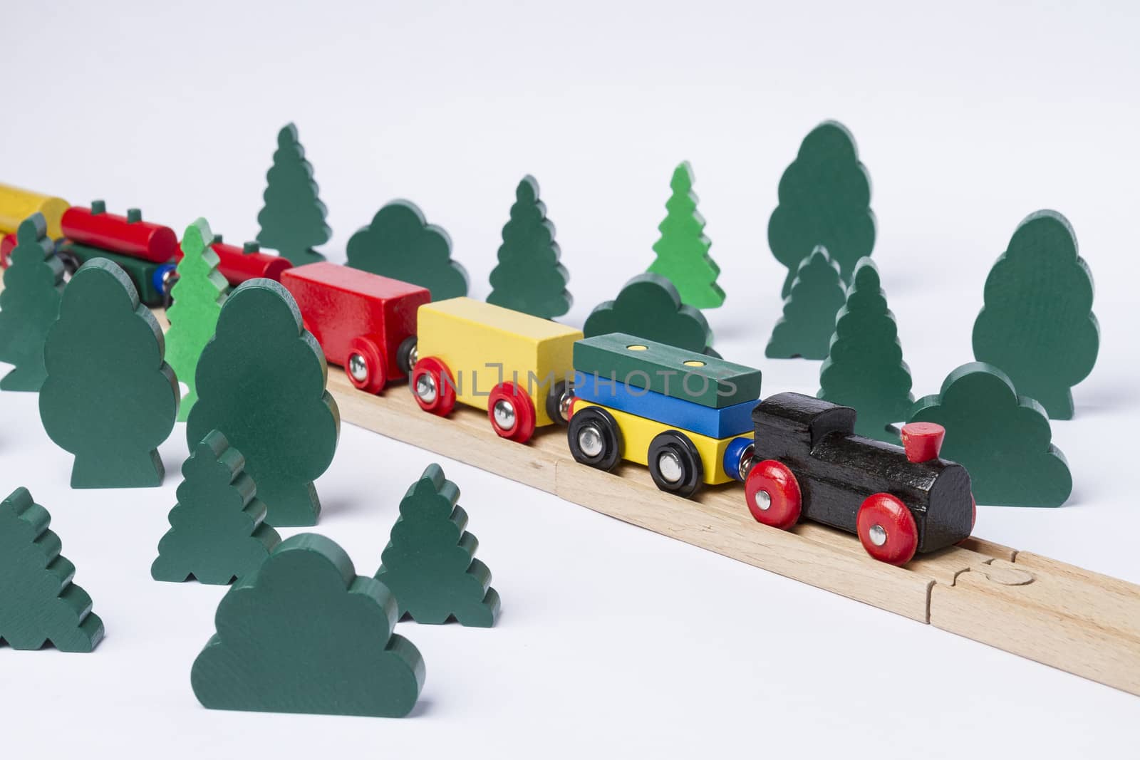 fast train driving through small forest. scenery made of wooden toy