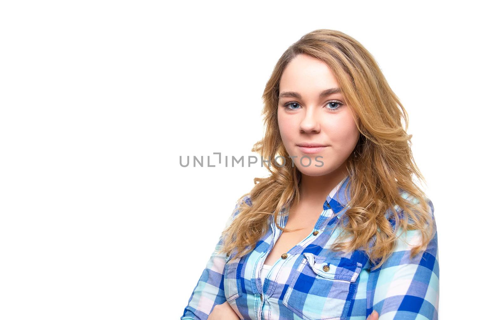 Portrait of beautiful blonde teenager student with blue plaid shirt posing on white background