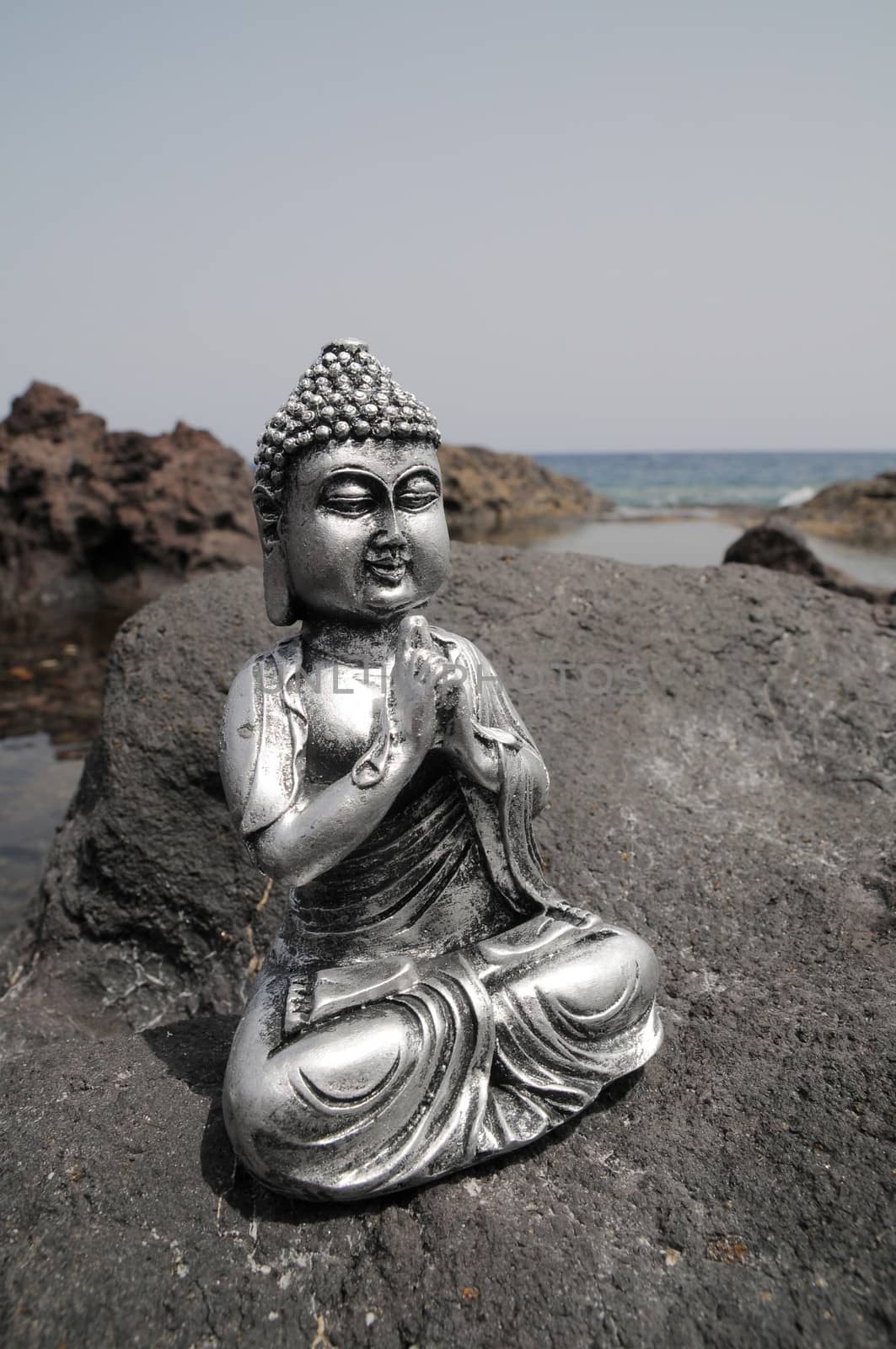 One Ancient Gray Buddha Statue Near The Ocean