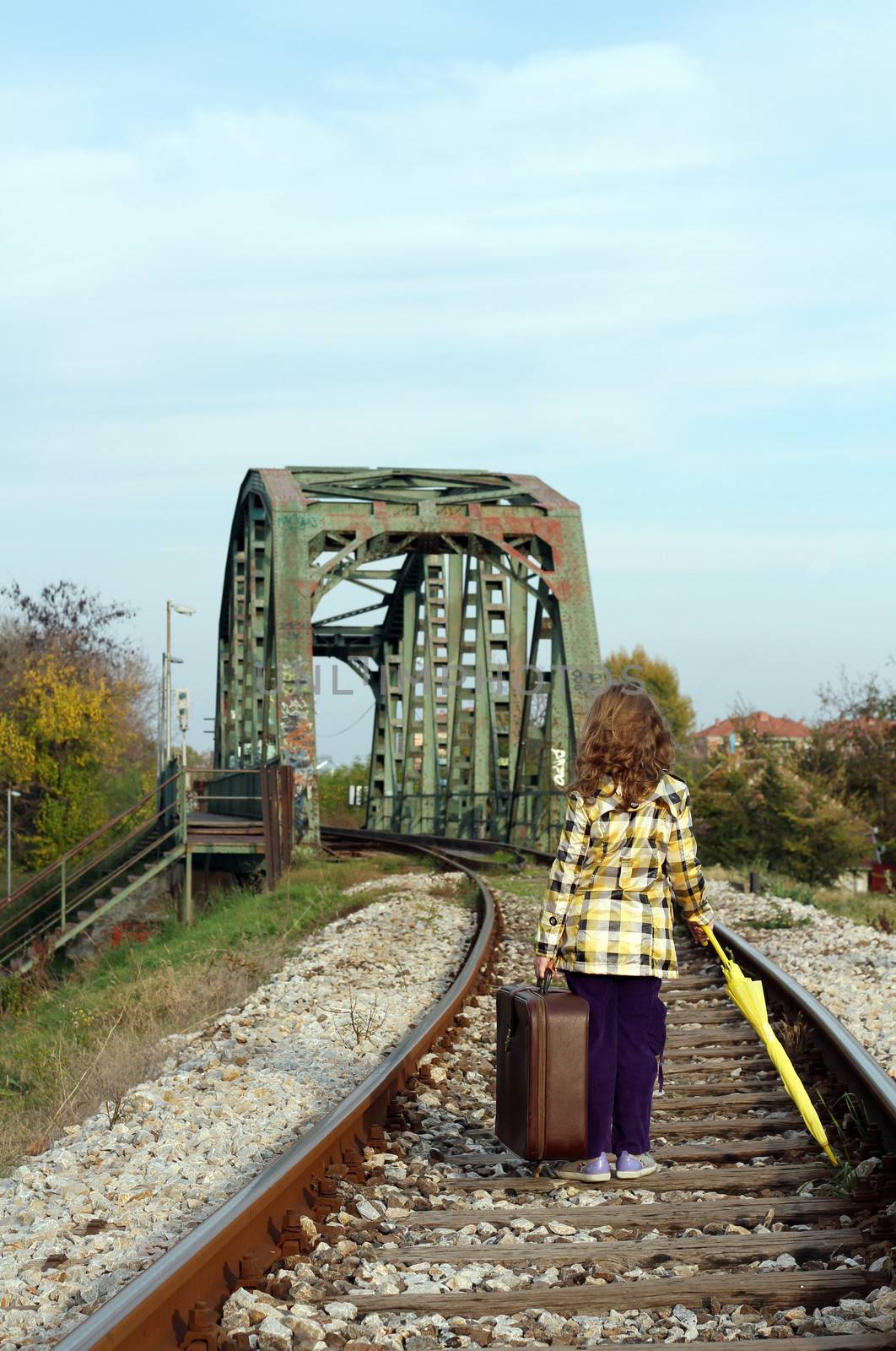 little girl walking on railroad by goce