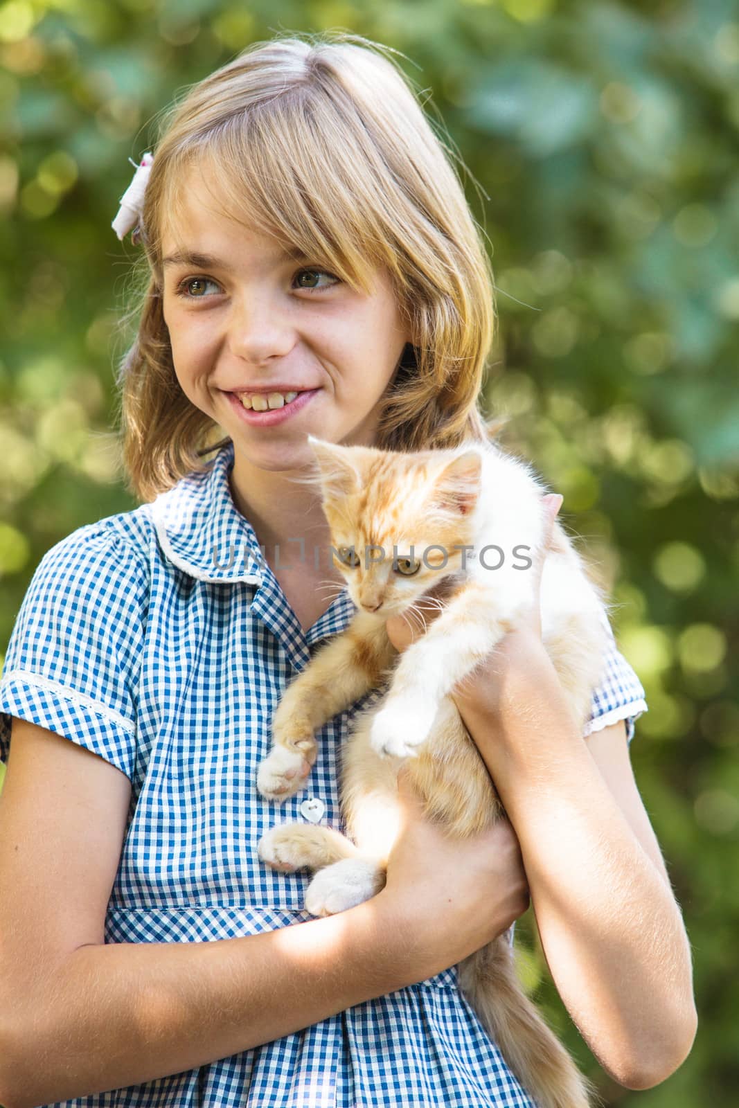 Girl play with kitten outdoor in the park