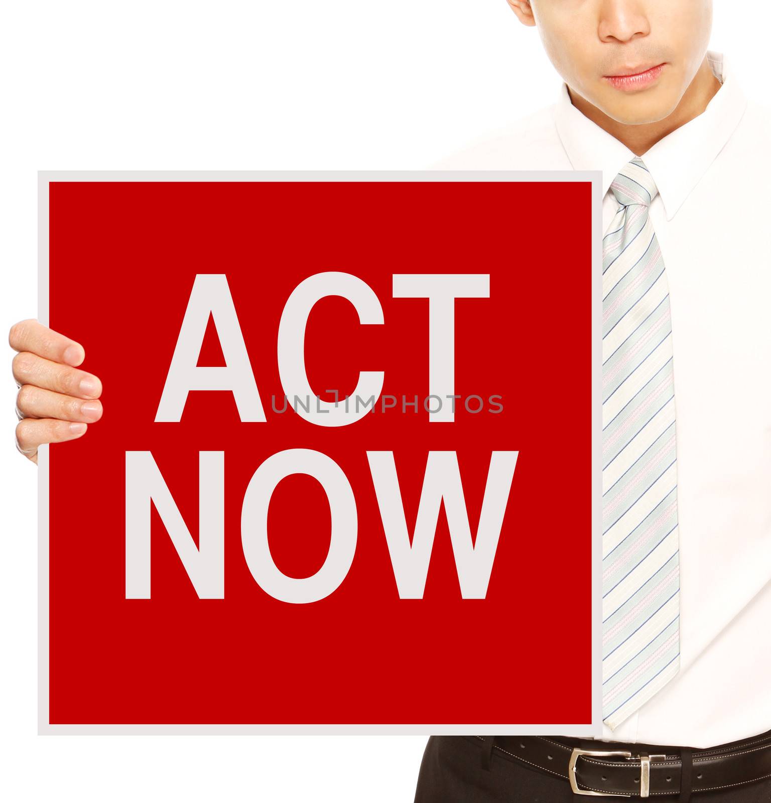 A businessman holding a sign indicating Act Now