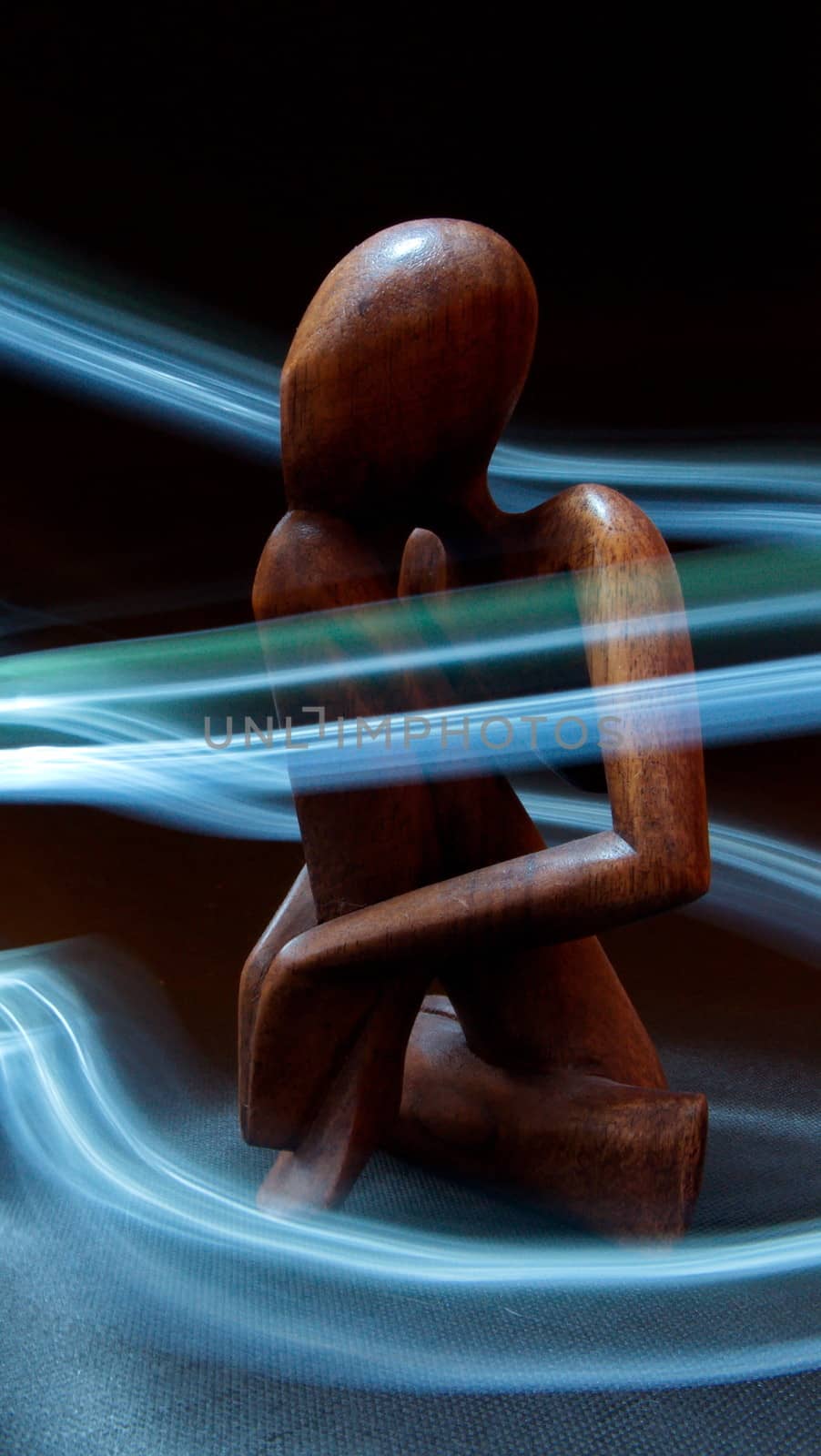 Wooden figure surrounded by light