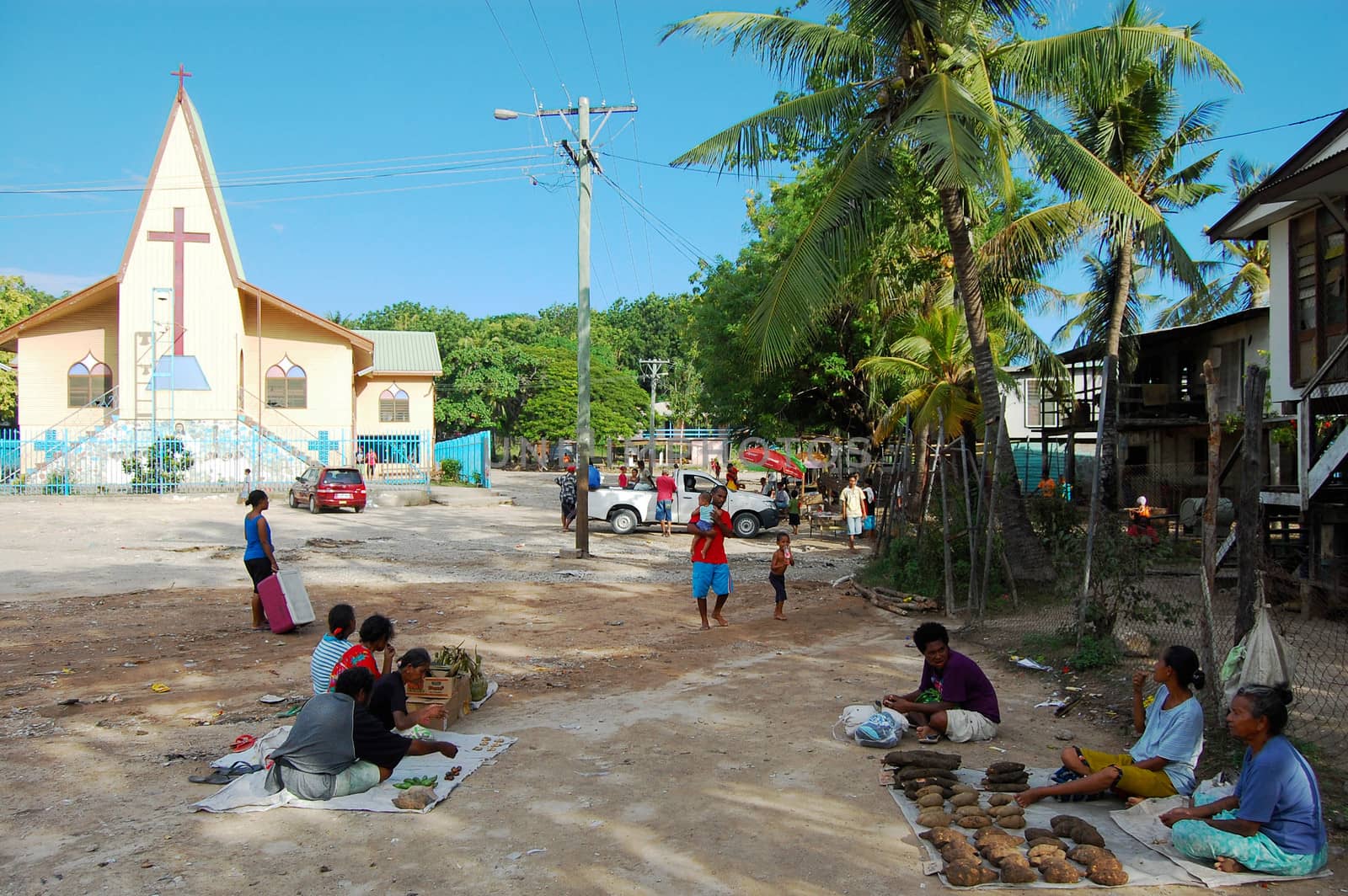 Village market near christian church building by danemo