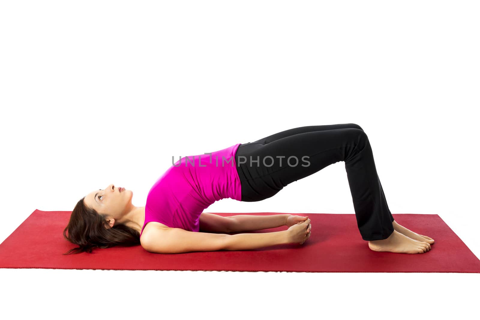 Young woman doing Bridge Pose in Yoga and Pilates (Series with the same model available)