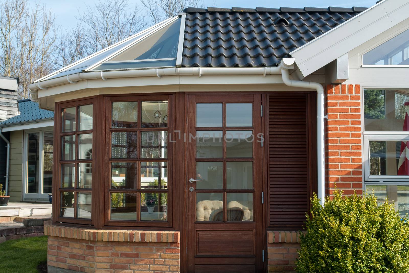 Modern design conservatory made of wooden frame and glass