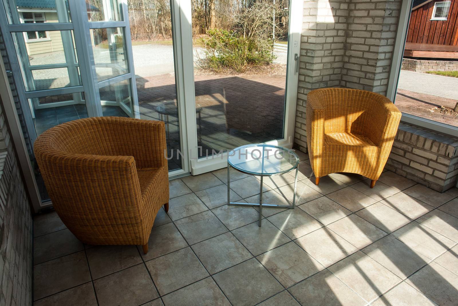 Country style seating corner inside a modern conservatory