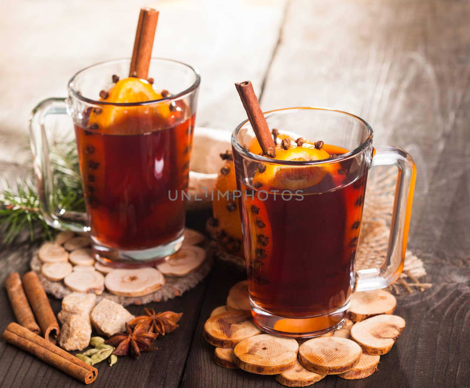 A mulled wine in the glass cup on wooden background