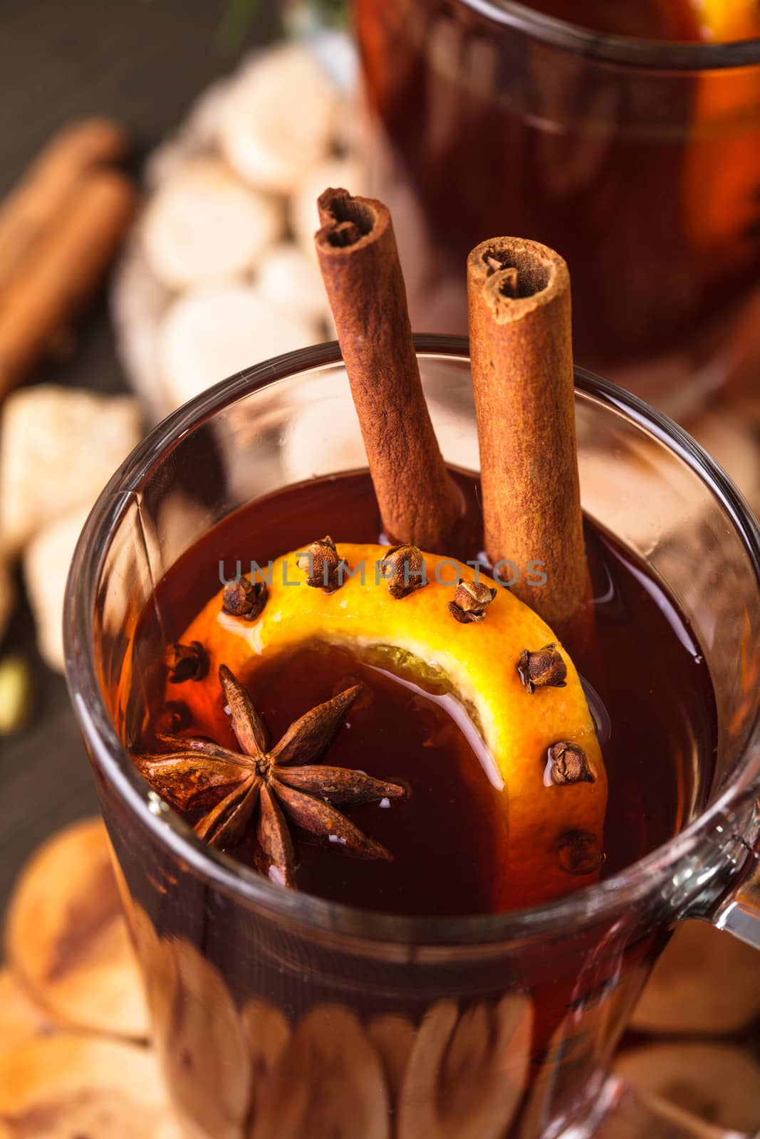 A mulled wine in the glass cup on wooden background