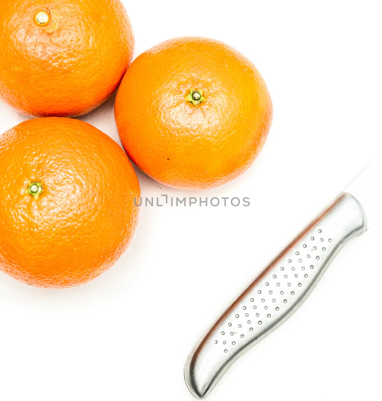 Three oranges and one fruit knife isolated on white background