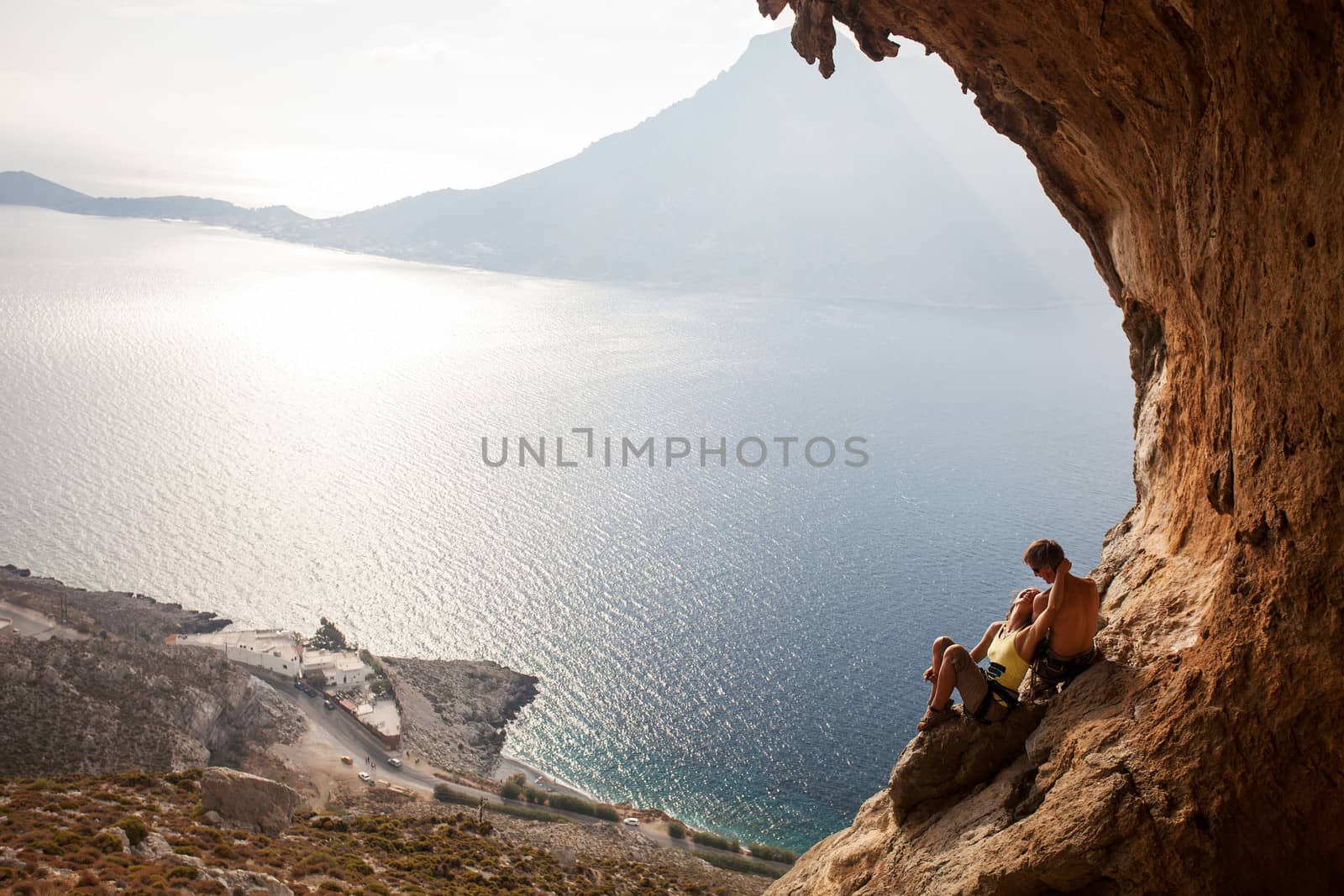 Young couple of rock climbers having a rest. Kalymnos Island, Greece.