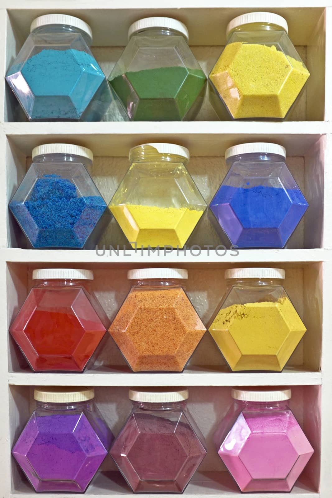 Assortment of glass jars on shelves in herbalist shop in marrakesh, morocco, containing herbs and spices for medicinal and culinary purposes