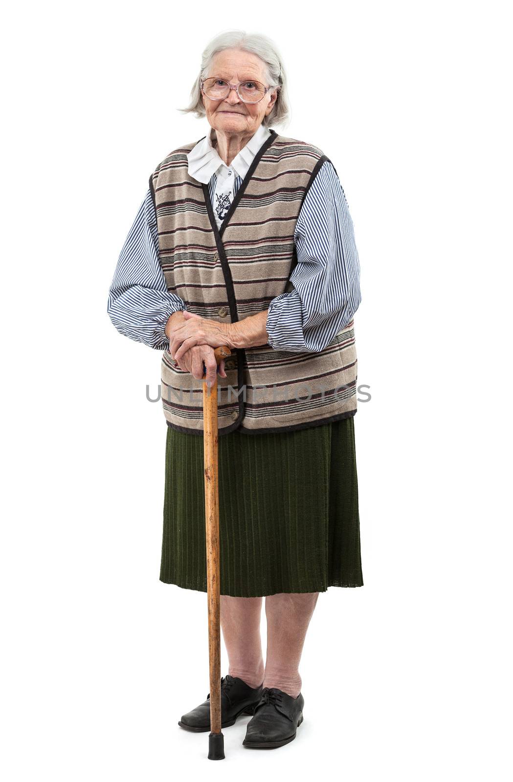 Old woman with a cane over white background by photobac