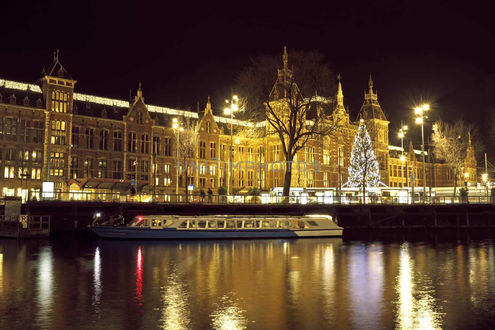 City scenic from Amsterdam in the Netherlands with the central station at night