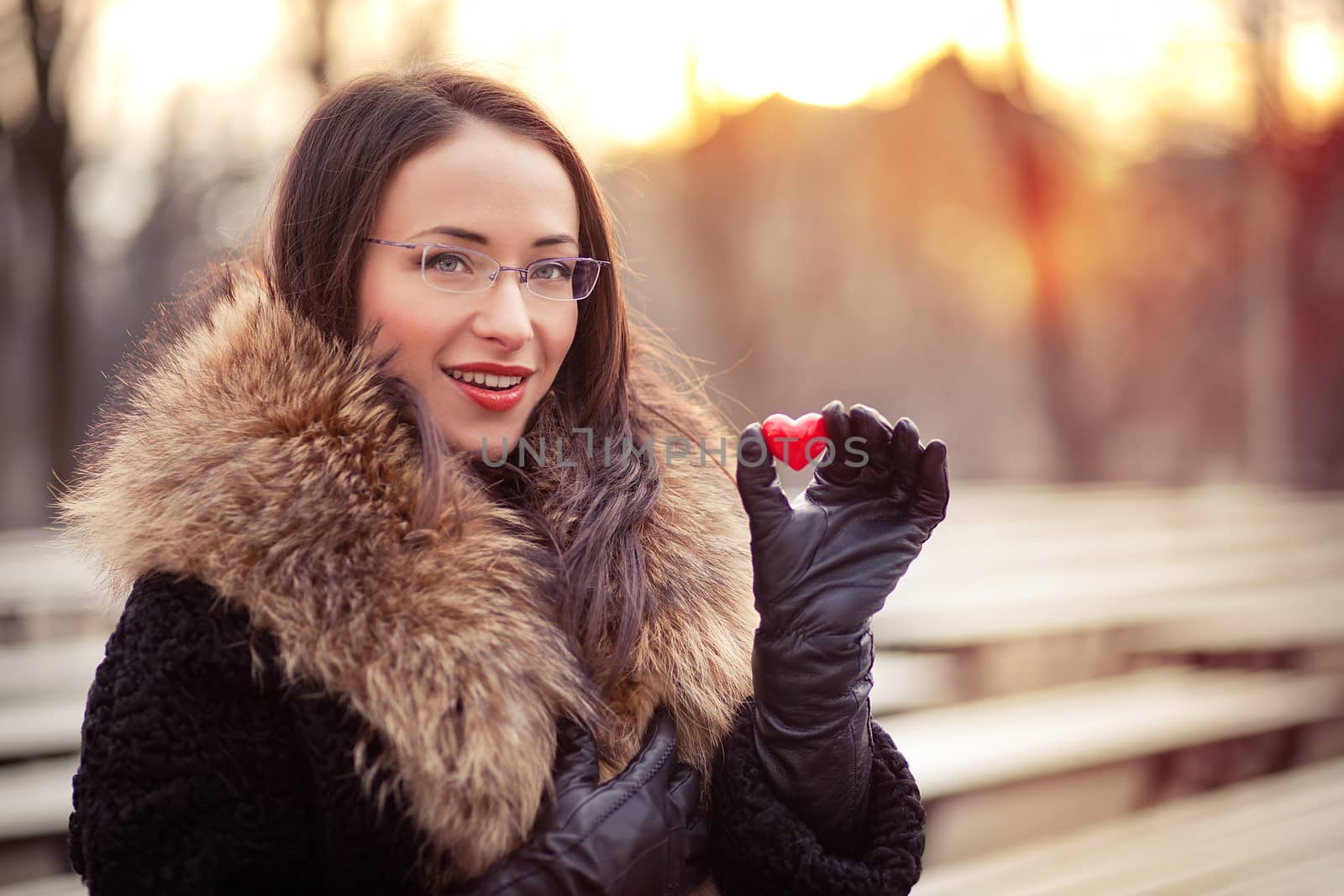 Pretty woman holding red heart on Valentines day