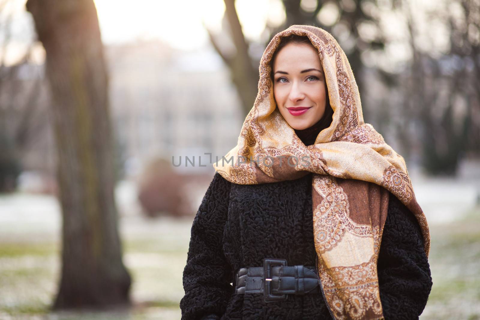 Smiling young and happy business woman wearing scarf