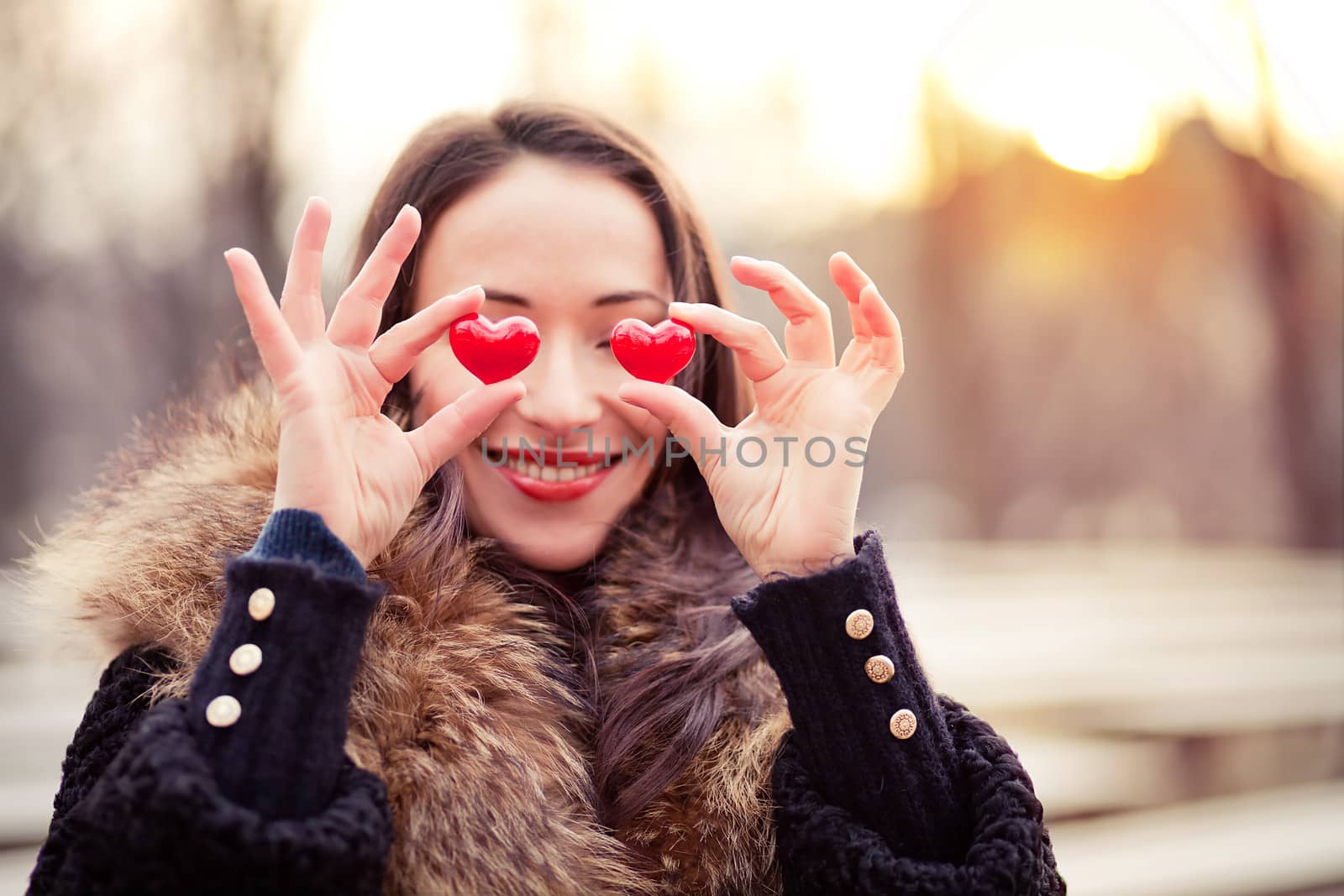 Pretty woman holding red hearts on Valentines day