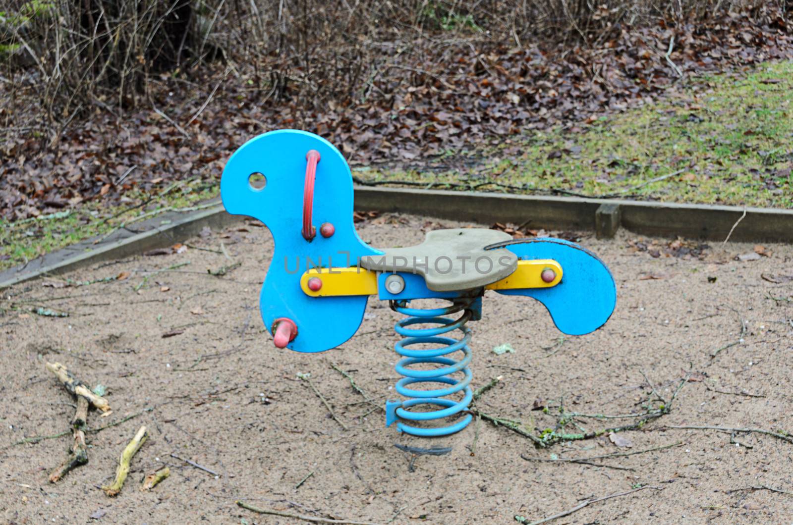 out toy rocking horse for the kids on playground in the woods