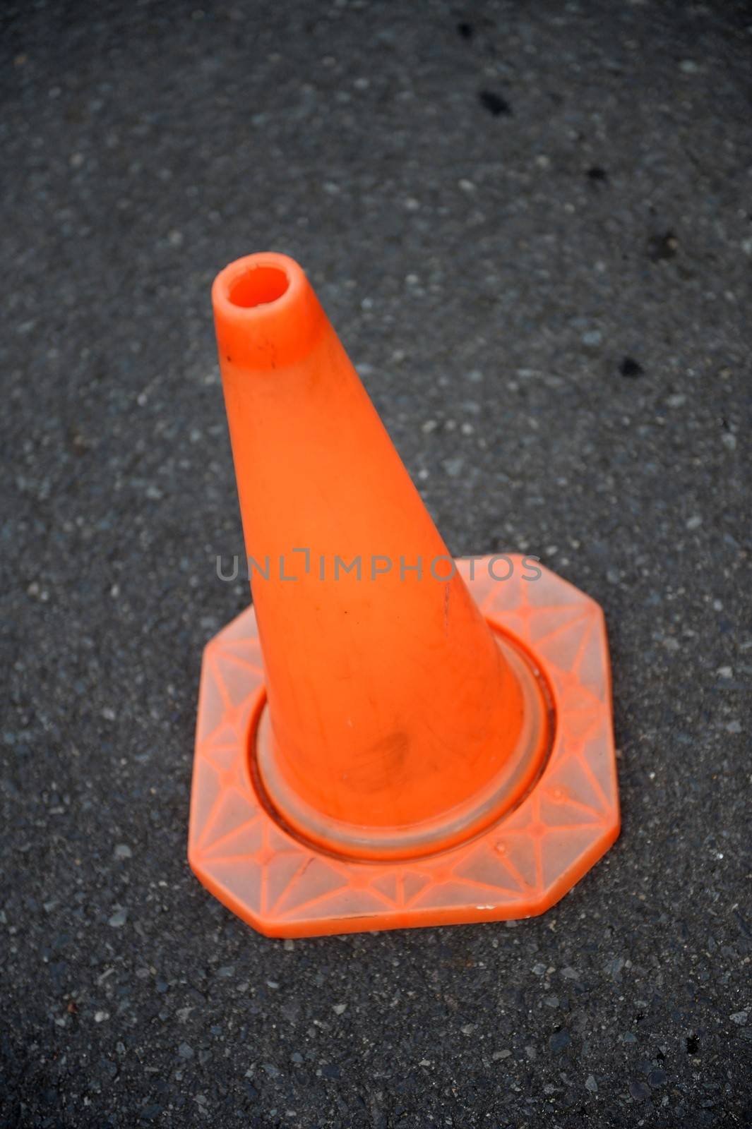 A close up shot of a safety cone on a road