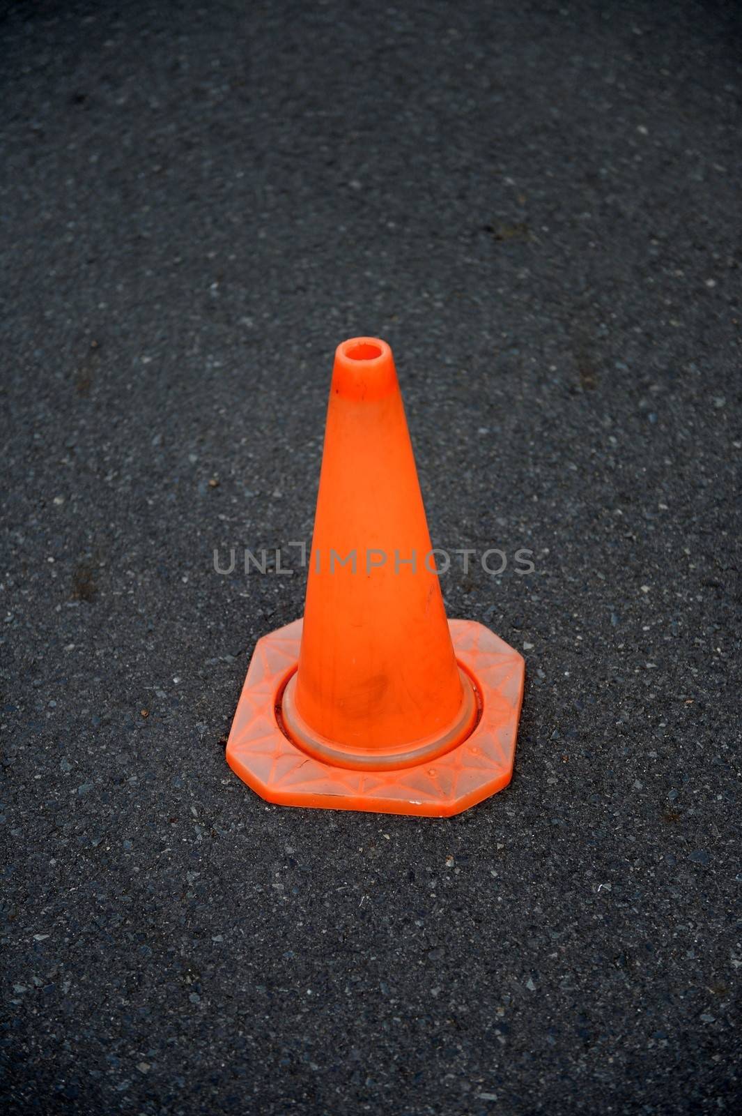 A close up shot of a safety cone on a road