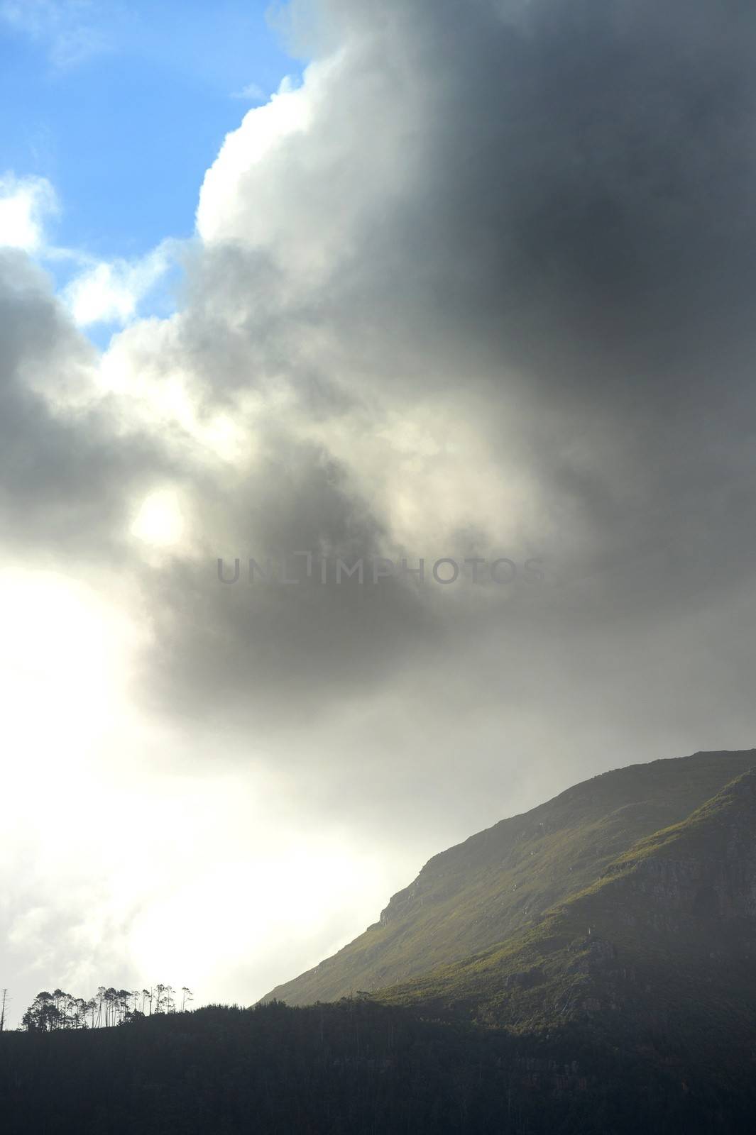 A landscape shot of a mountain range with storm clouds