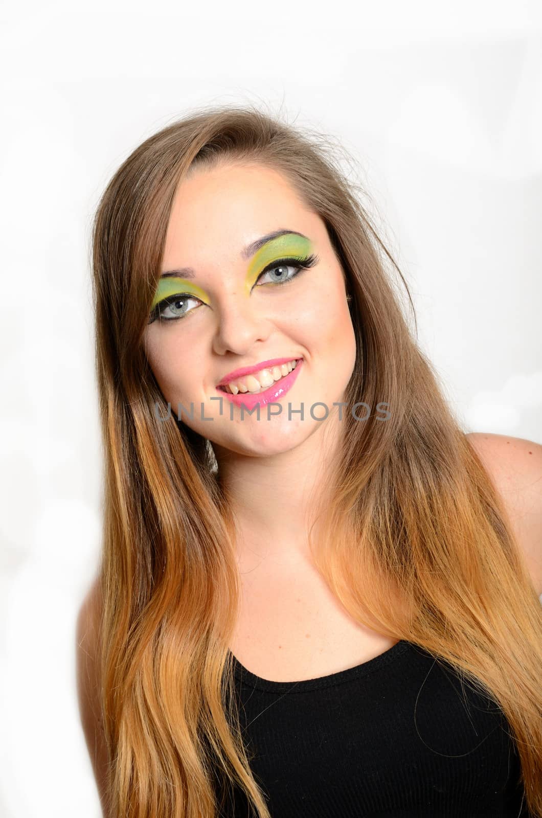 Close up portrait of young female model with blond hairs. Teenager from Poland, smiling face and colorful makeup.