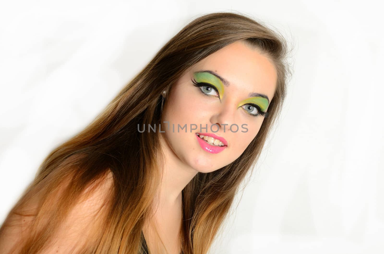 Close up portrait of young female model with blond hairs. Teenager from Poland, smiling face and colorful makeup.