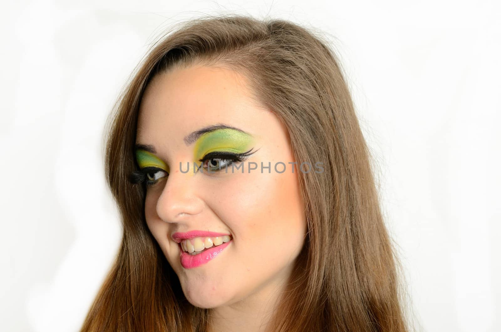 Portrait of young female model with colorful makeup. Polish girl with gentle smile, kind and sincere.