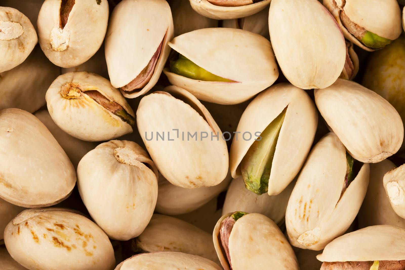 Pistachio nuts close up from above.