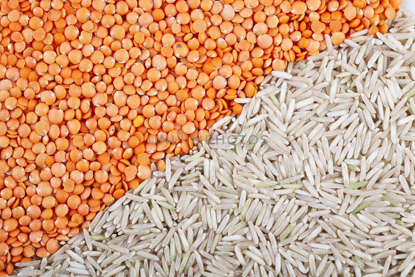 Red lentils and brown rice background split diagonally
