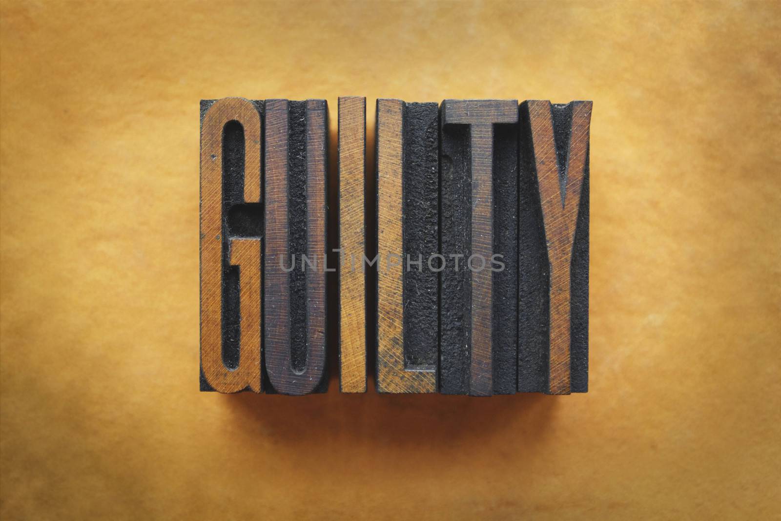 The word GUILTY written in vintage letterpress type.