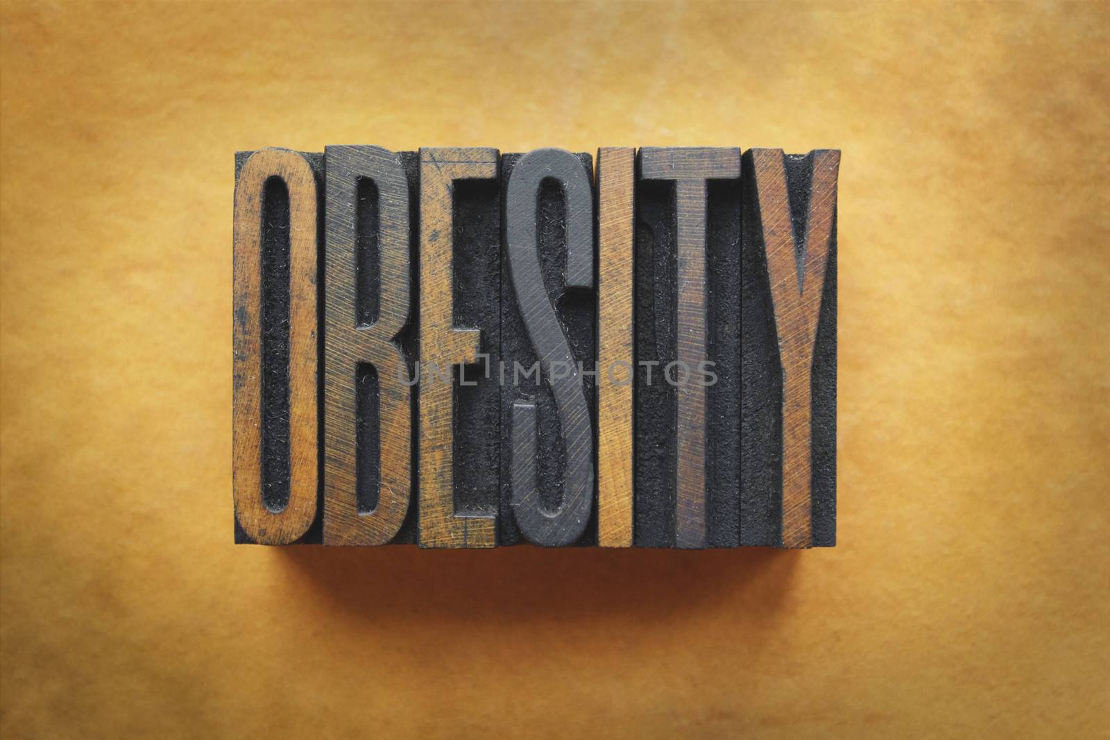 The word OBESITY written in vintage letterpress type.