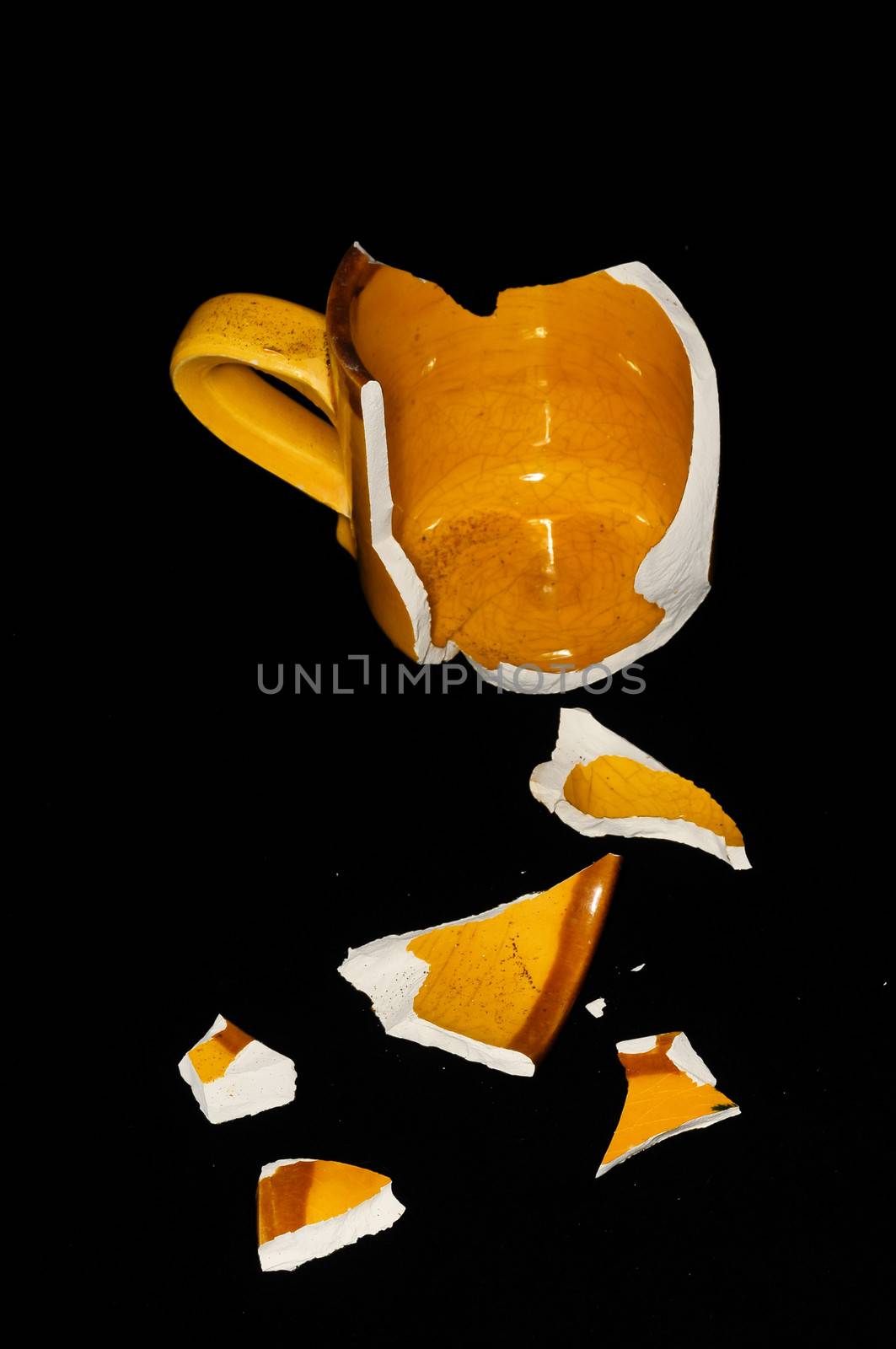 Broken Orange Coffee Cup on A Black Bacground