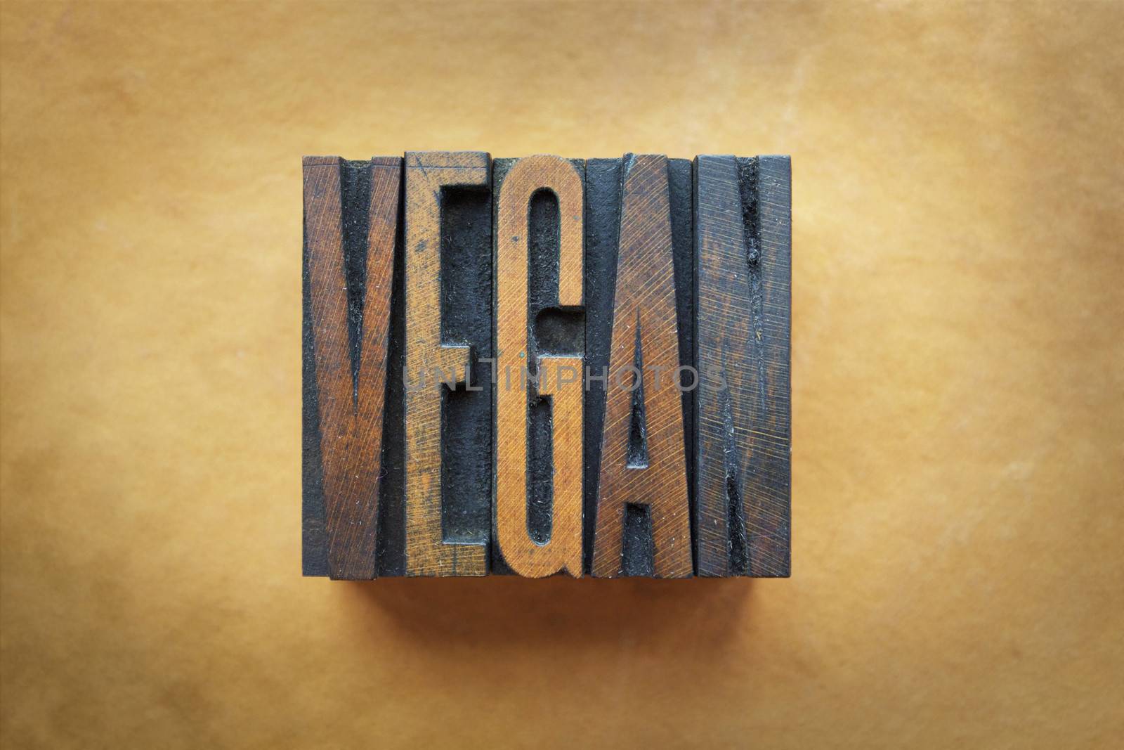 The word VEGAN written in vintage letterpress type.