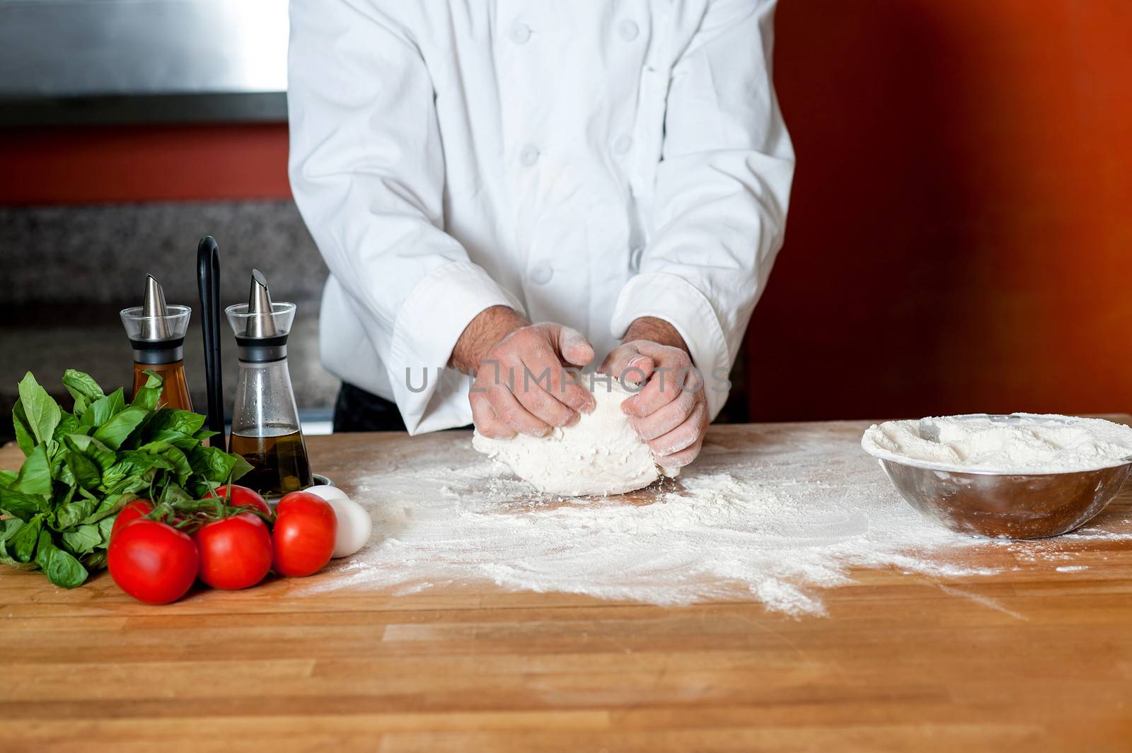 Hands of male chef preparing pizza dough