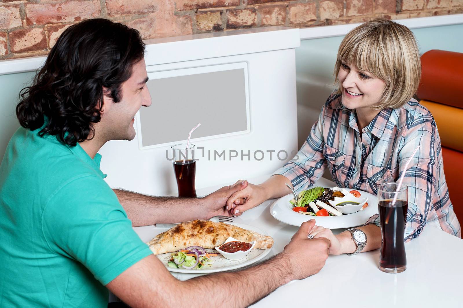 Couple enjoying dinner at a restaurant by stockyimages