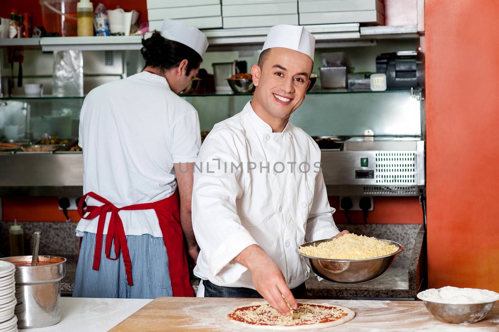 Chefs at work inside restaurant kitchen by stockyimages